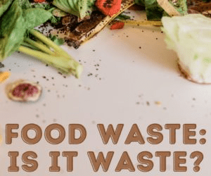 Fresh vegetables and food scraps scattered on a surface, highlighting the issue of food waste, with the text "Food Waste: Is It Waste?" prominently displayed.