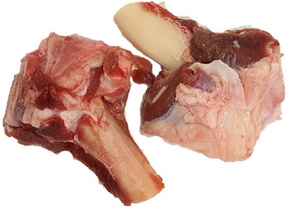 Raw meat cuts featuring bone, showcasing marbled fat and muscle tissue, relevant for culinary discussions on ingredients or recipes.