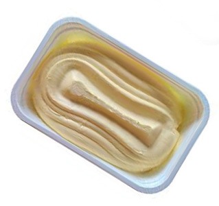 Smooth, creamy butter displayed in a rectangular container, showcasing an appealing texture and inviting color, perfect for cooking and spreads.