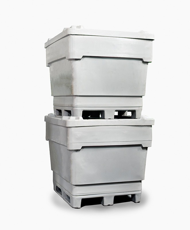 Stacked gray storage containers on pallets, designed for bulk handling and efficient transport. Ideal for warehouse organization or shipping.