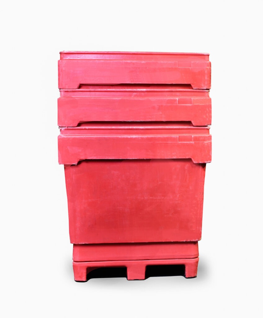 Three stacked red plastic containers on a pallet, showcasing durable storage solutions for commercial or industrial use.