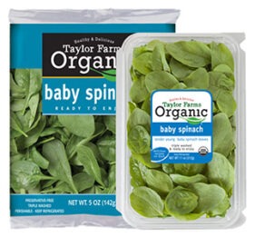 Organic baby spinach packaging from Taylor Farms, featuring a plastic container and a bag. Ideal for fresh salads and healthy meals.