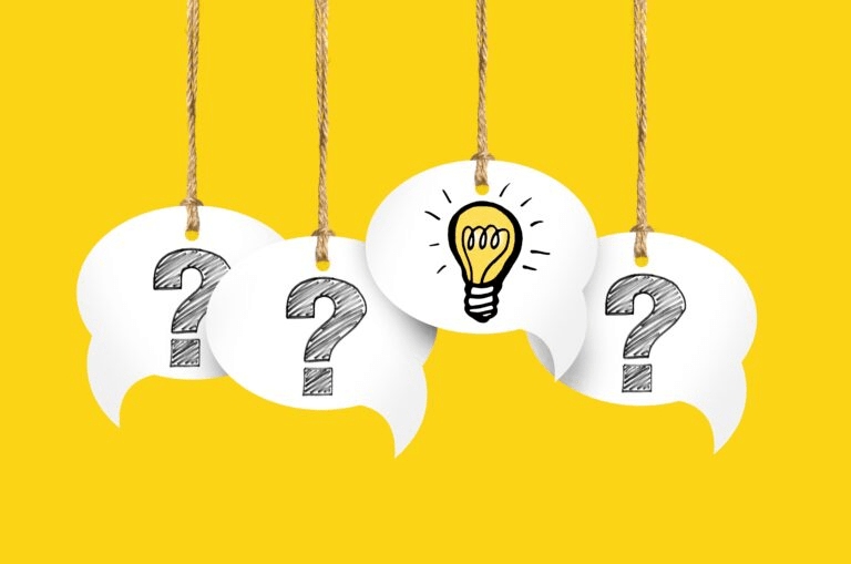 Four speech bubbles hang from ropes against a bright yellow background, featuring question marks and one light bulb, symbolizing ideas and inquiries.