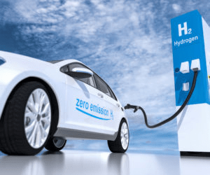 Hydrogen fuel cell vehicle refueling at a station. The car displays "zero emissions H2," highlighting its eco-friendly technology.