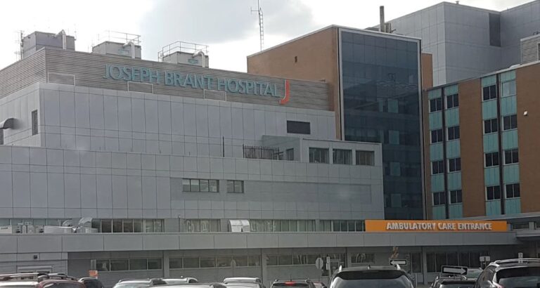 Joseph Brant Hospital's exterior features a modern design with a prominent sign and an orange "Ambulatory Care Entrance" for patient access.