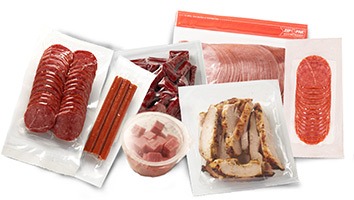 An assortment of vacuum-sealed meats including slices of salami, jerky, pepperoni sticks, and cooked chicken, showcasing various options for snacking or meal preparation.